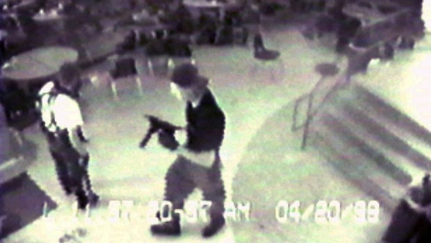 Eric Harris, left, and Dlyan Klebold, carrying a TEC-9 semi-automatic pistol, are pictured in the cafeteria at Columbine High School, in Littleton, Colorado, during their shooting rampage in 1999.