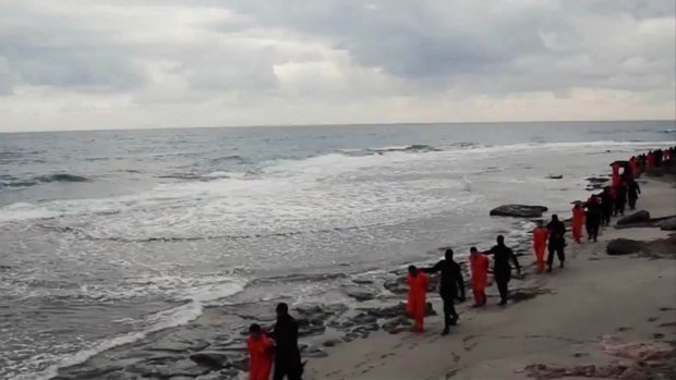 Masked Islamic State militants in Libya lead Egyptian Coptic Christians in orange jumpsuits along a beach before executing them on February 15, 2015.