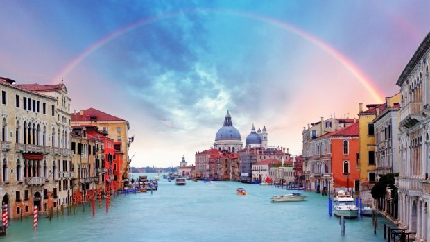A rainbow forms over the Grand Canal in Venice.