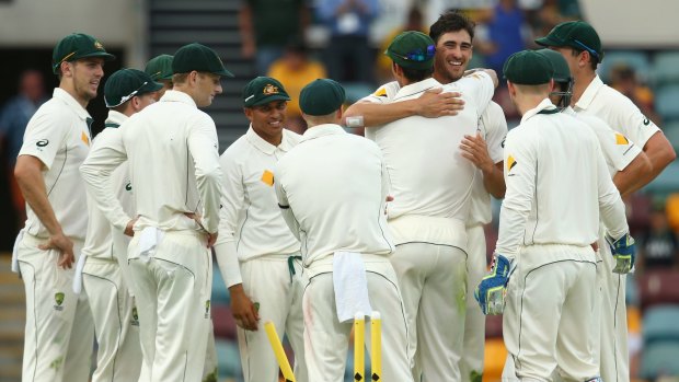 Mitch craft: Mitchell Starc embraces Mitchell Johnson after clean bowling James Neesham on day two of the first Test.