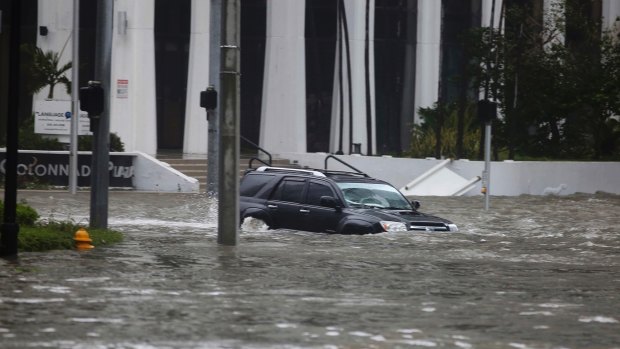 A vehicle drives on flooded Brickell Avenue in Miami on Sunday as Hurricane Irma passes. 
