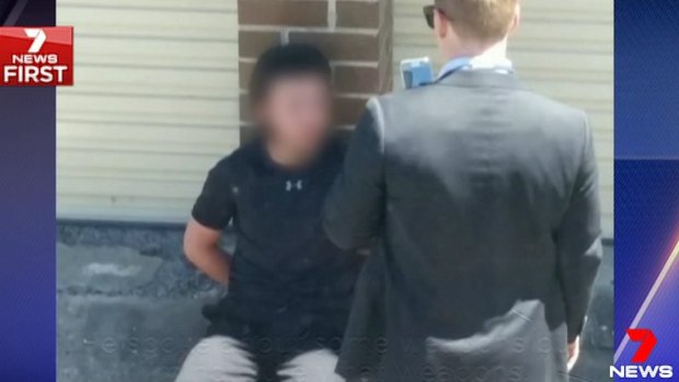 One of the 16-year-old boys, who cannot be identified for legal reasons, was filmed abusing police as he sat handcuffed in Adnum Lane on October 12.