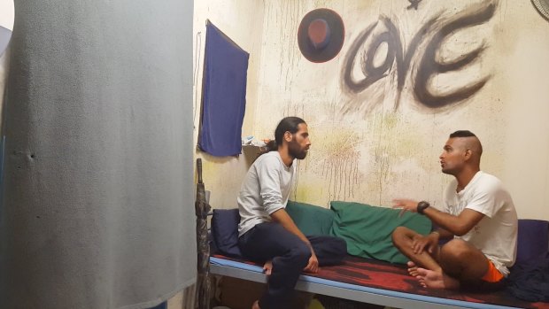 Behrouz Boochani, left, interviews a fellow asylum seeker in Chauka, Please Tell Us the Time.