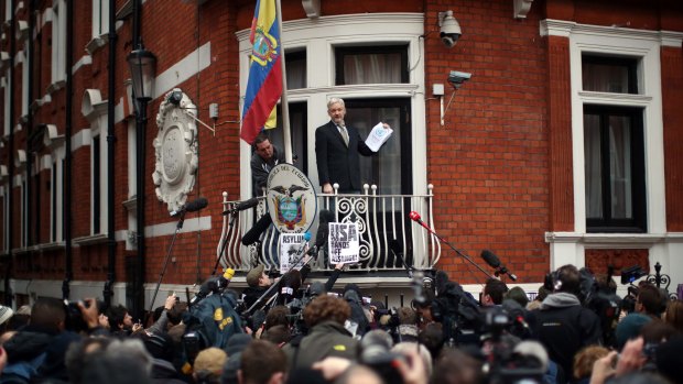 Julian Assange speaks from the balcony of the Ecuadorian embassy in London in February.