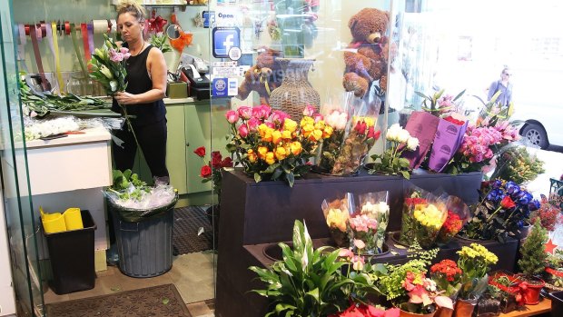 "It was hard to keep it together": Glasshouse florist owner Tracey Hemus prepares flowers on Wednesday.