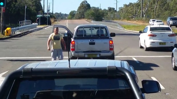 The man walks back to his vehicle after confronting the woman on the NSW central coast.