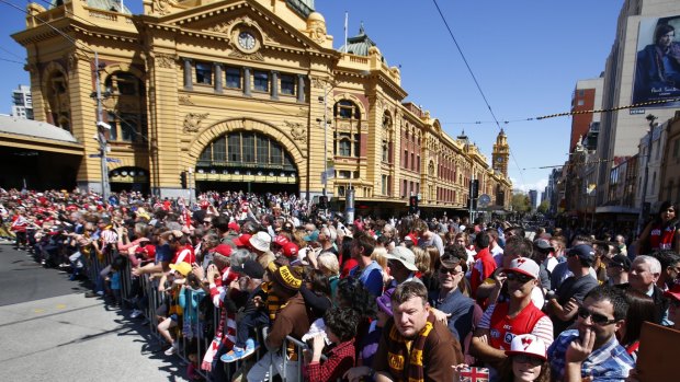 Crowds gather for the grand final day parade in 2014. 
