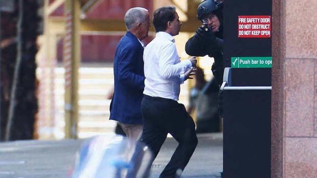 John O'Brien and Stefan Balafoutis flee from the Lindt cafe during the siege.