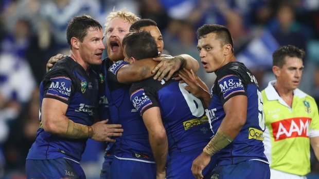 Josh Reynolds of the Bulldogs celebrates with his team mates after scoring a try.