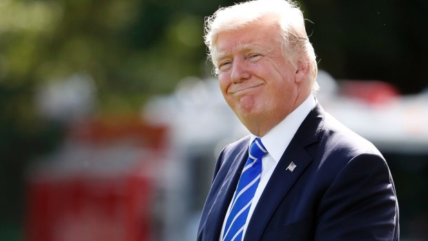 President Donald Trump smiles as he walks to Marine One on the South Lawn the White House.