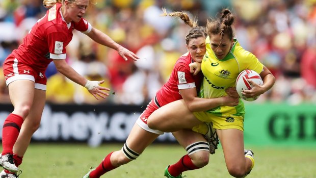 Sent packing: Evania Pelite of Australia is tackled during the semi-final loss to Canada.