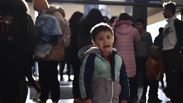 A refugee boy who fled conflict from neighboring Ukraine cries at the railway station after arriving to Zahony, Hungary