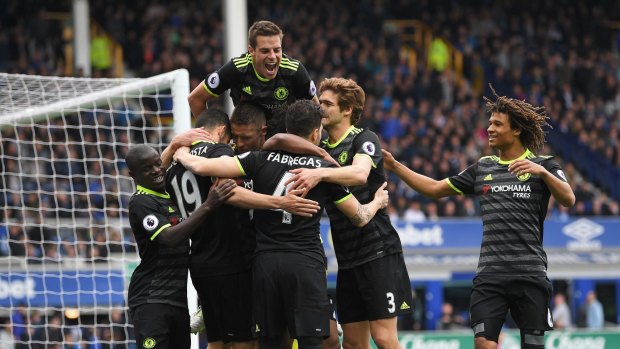 Chelsea players celebrate the side's third goal against Everton.