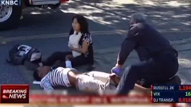 A first responder attends to a person outside the Southern California social services centre in San Bernardino, where multiple people were shot on Wednesday.