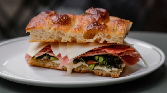 Greta's deli sandwich with sopressa, provolone, cime di rapa and artichoke aioli.