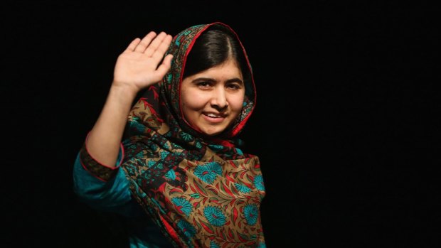 Malala Yousafzai waves to the crowd at a press conference at the Library of Birmingham after being announced as a recipient of the Nobel Peace Prize, on October 10, 2014 in Birmingham, England.