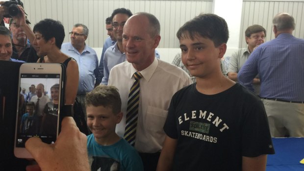 Premier Campbell Newman, campaigning in Mackay, stops for a photo with Rhys Thompson, 9, and Bryce Thompson, 13.