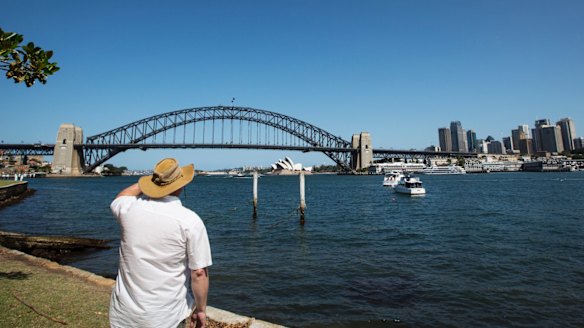 A tourist takes in the view from Blues Point Reserve.