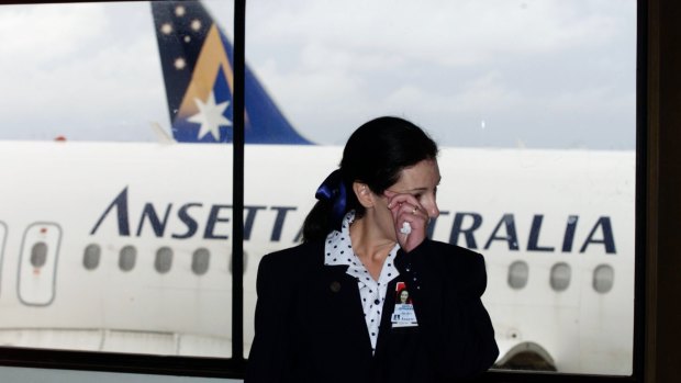 A flight attendant shows the strain in between Melbourne to Sydney flights on Ansett's last day at Sydney Airport.