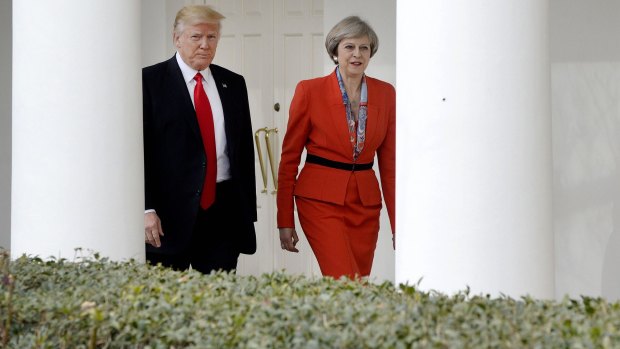 President Donald Trump walks with Theresa May outside of the White House.