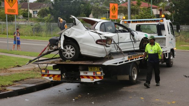 The car is towed away after a crash that killed three women.