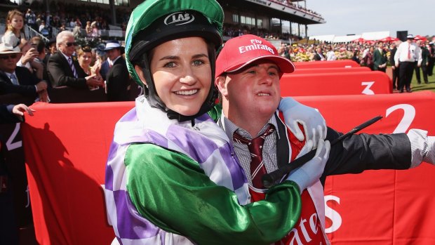 Michelle Payne celebrates her winning Melbourne Cup ride on Prince Of Penzance with brother and strapper Stephen Payne.