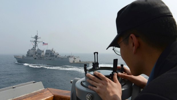 A South Korean navy sailor watches the destroyer USS Wayne E. Meyer during a joint exercises between the United States and South Korea.
