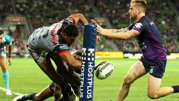 New No.1: David Fusitua, left, of the Warriors unsuccessfully attempts to score a try during Monday night's clash with the Melbourne Storm in Melbourne.