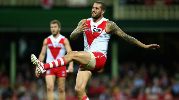 Injured: Lance Franklin of the Swans kicks against the Crows on Saturday night.