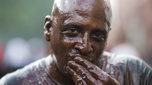 A man covered in chocolate during the Notting Hill Carnival in London, England. 