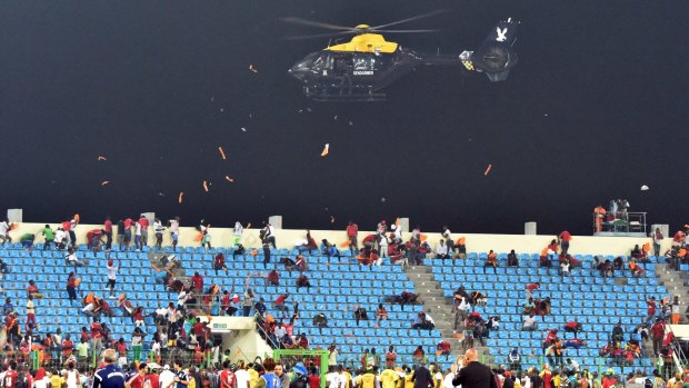 A police helicopter flies over the stadium 