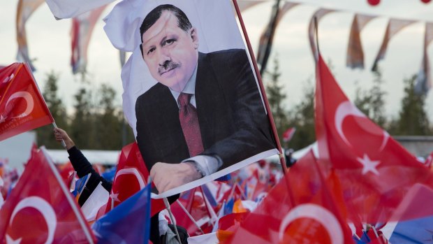 A flag at an election rally bears the likeness of Recep Tayyip Erdogan.