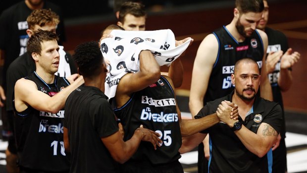 Breakers players applaud Akil Mitchell as he is helped off the court after suffering a serious eye injury on Thursday night.