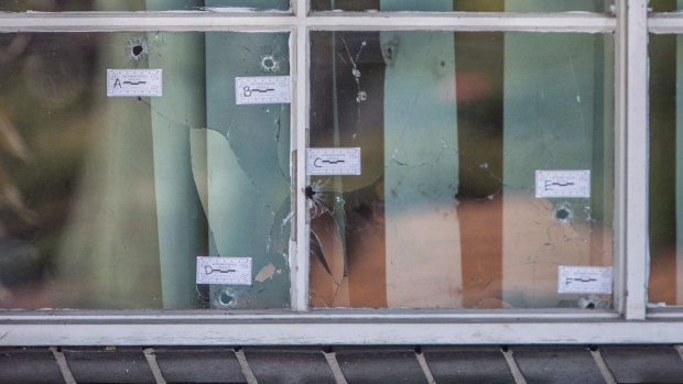  The six bullet holes in the window of a Darebin Drive property in Thomastown. 
