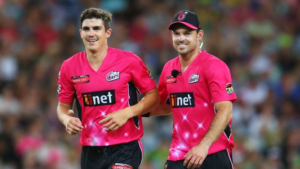 World Cup bolter: Sean Abbott of the Sixers (left) celebrates after claiming the wicket of Andrew McDonald of the Thunder during the Big Bash League match on December 27.