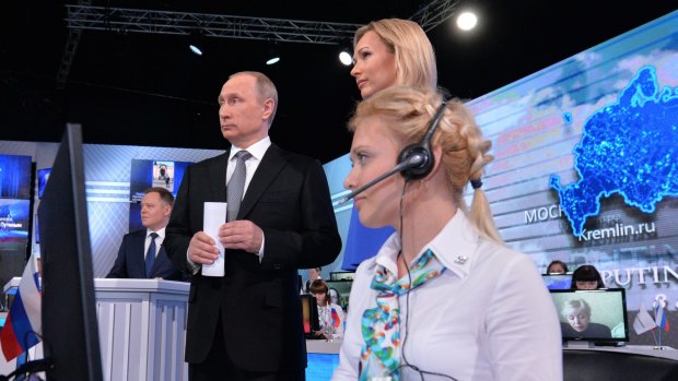 Russian President Vladimir Putin stands next to TV presenter Valeria Korablyova, during his marathon call-in TV show in Moscow.