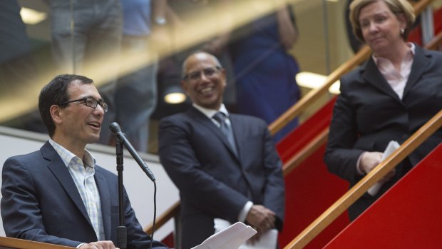 The New York Times executive editor Dean Baquet, center, listens as reporter Eric Lipton, who won the Pulitzer Prize for Investigative Reporting, speaks.