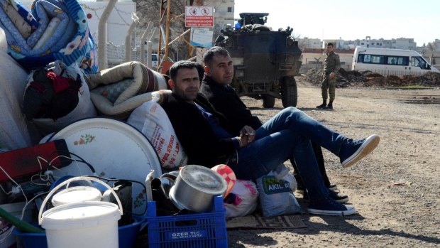 Kurds wait at the Mursitpinar border crossing in readiness for a return to Kobane. 