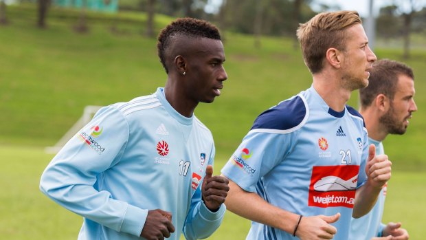 "We have to be very focused against Melbourne Victory": Janko during a warm-down session with teammates Bernie Ibini and Matt Jurman.