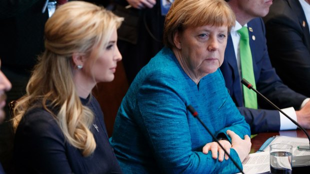 German Chancellor Angela Merkel sits next to Ivanka Trump during a roundtable discussion.