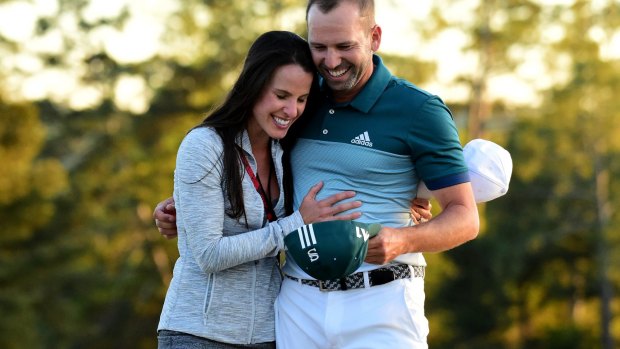At last: Sergio Garcia embraces fiancee Angela Akins after defeating Justin Rose.