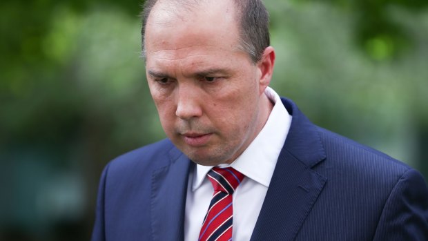 Immigration Minister Peter Dutton departs after addressing the media during a doorstop interview on the Christmas Island situation, at Parliament House in Canberra on Tuesday.