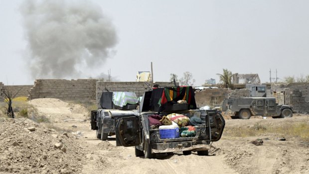 Smoke rises after an airstrike by US-led coalition warplanes as Iraq's elite counterterrorism forces enter Shuhada.