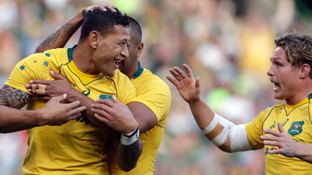 Australia's Israel Folau celebrates with teammates after scoring a try against South Africa.