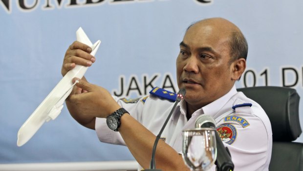 Soerjanto Tjahjono holds a model plane during the news conference.
