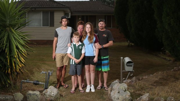 Greg Saunders and his partner Alison Hale with their children, Tom 10, and Bronte, 15. They are living in a caravan at the home of Alison's son Dylan, left. 