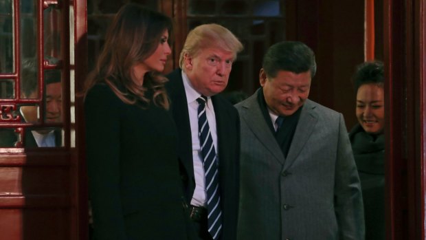 President Donald Trump, center left, first lady Melania Trump, left, accompanied by Chinese President Xi Jinping, center right, and his wife Peng Liyuan, right, tour the Forbidden City.