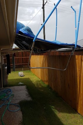 A trampoline was lifted and dumped during Tuesday's storms, putting a hole in a Kallangur resident's roof and causing the ceiling to leak.