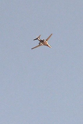 A military plane flies above Kobane on Wednesday.
