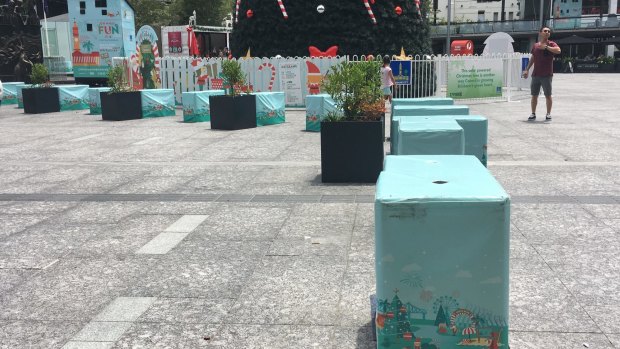 Concrete blocks, covered in Christmas wrapping, were installed around Brisbane's King George Square earlier in December.